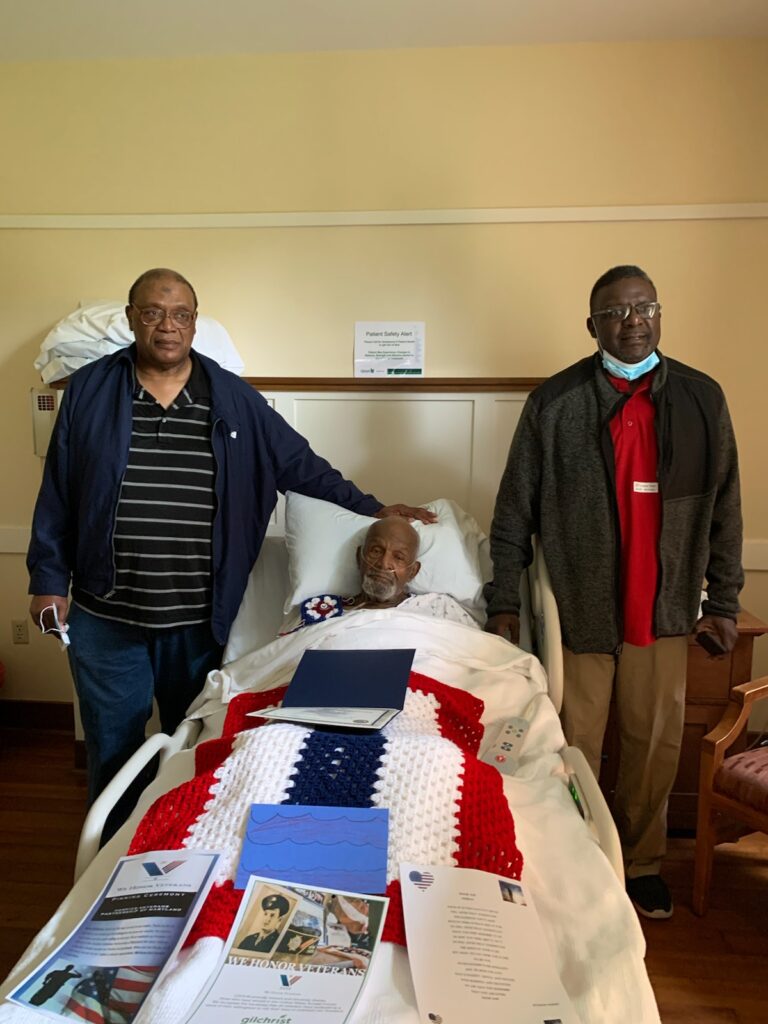 Daniel Edward Moore (center), a veteran of the Korean War, is flanked by two of his sons, Celetha X. W. Moore (left), and Danny Moore, both of them military veterans like their father.