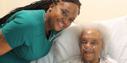 Patient with hospice aide smiling
